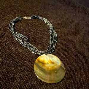 Beaded shell necklace, black beaded strand with large shell pendant